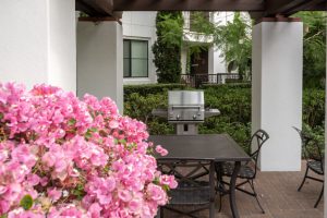 Outdoor grilling station with BBQ grills and tiled counter.