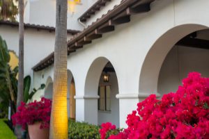 Outdoor corridor with arched architecture and hanging lanterns.