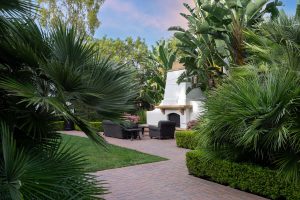 Outdoor lounge area with a fireplace and seating.