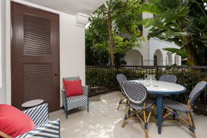 Private patio with seating and plant décor.