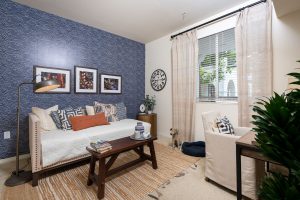Cozy living room with sofa, chair, and wall art.
