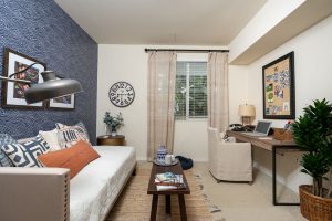 Cozy living room with sofa, chair, and wall art.