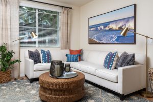Cozy living room with sofa, chair, and wall art.